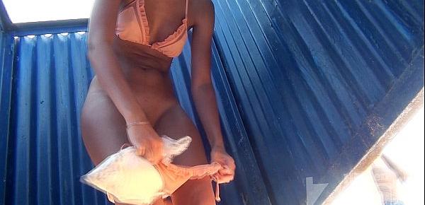  Tanned hottie with shaved cunt in the beach cabin.